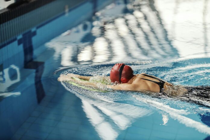 Professional sports girl in action A swimmer swimming in long axis stroke style