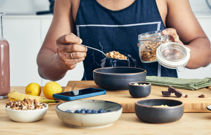 Fit & healthy man making oatmeal for breakfast