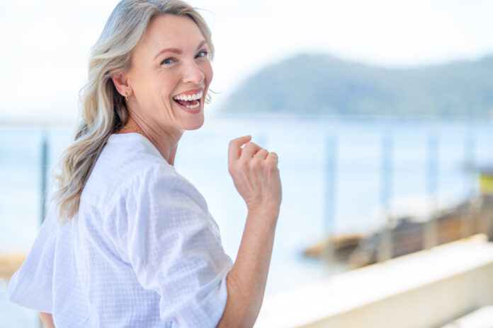 Beautiful mature woman portrait at waterfront house